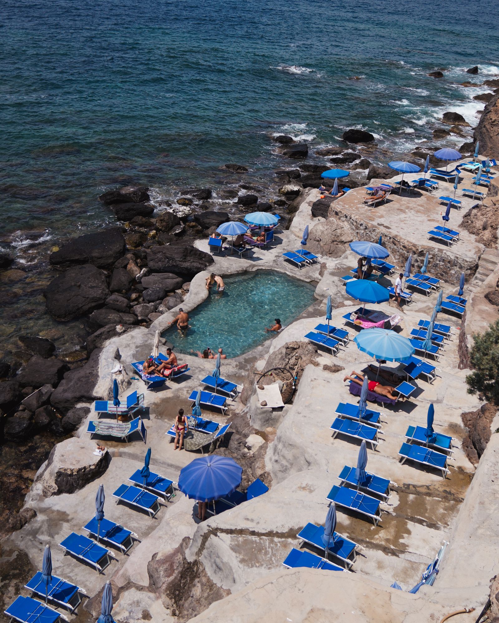 Image may contain Pool Water Swimming Pool Rock Summer Nature Outdoors Sea Beach Coast Shoreline and Person