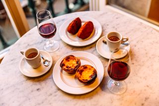 Pastel de nata and dried cod croquettes served with Portuguese port wine at the restaurant Lisbon Portugal