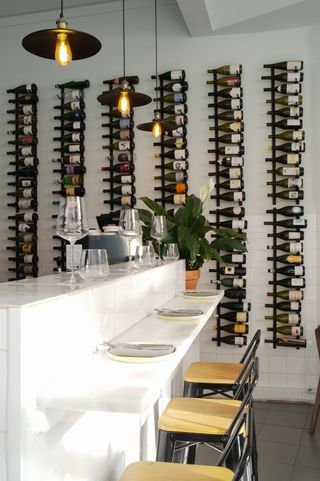 Image may contain Alcohol Beverage Liquor Wine Wine Cellar Cup Lamp Chair Furniture and Plate