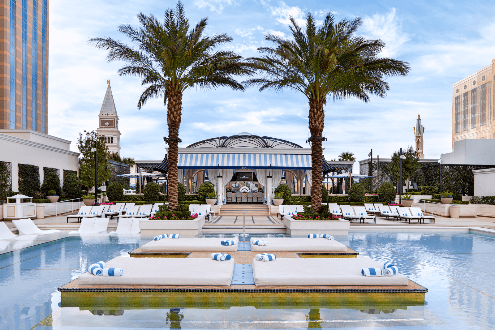 Image may contain Summer Architecture Building Hotel Resort Pool Water Plant Tree Swimming Pool and Chair